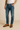 "Men’s name-brand blue denim jeans styled with brown leather dress shoes and white t-shirt, casual outfit for everyday wear, displayed on model against neutral background