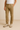 Men’s name-brand khaki pants styled with white t-shirt and beige suede dress shoes, casual-smart outfit for everyday or office wear, modeled against neutral background