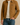 "Men’s tan suede zip-up jacket layered over cream sweater and blue jeans, high-end designer outerwear modeled for fall fashion against a neutral background."