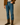 "Men’s dark brown Western cowboy boots styled with blue jeans, tan suede jacket, and cream sweater, name-brand and designer men’s boots modeled for casual fall fashion against neutral background."