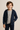 Smiling young boy wearing a navy zip-up hoodie, gray t-shirt, and navy pants, modeling name-brand boys' clothing for casual everyday wear against a neutral background