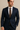 "Men’s navy blue tailored suit with white dress shirt and brown textured tie, name-brand formalwear modeled for business or special occasions against neutral background."